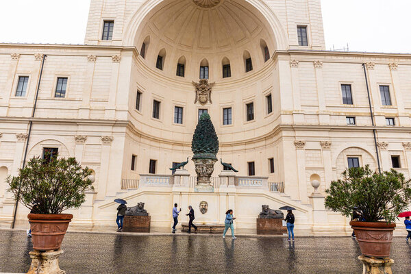 РИМ, ИТАЛИЯ - 28 ИЮНЯ 2019 года: люди с зонтиками ходят рядом со старым зданием
