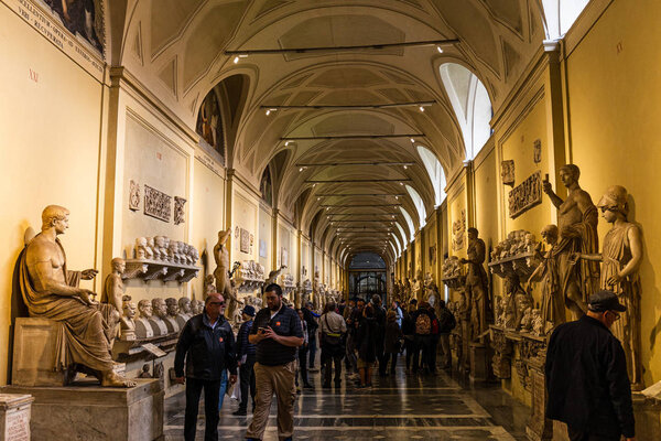 ROME, ITALY - JUNE 28, 2019: crowd of tourists walking in old museum with exhibition