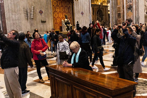 ROME, ITALY - JUNE 28, 2019: crowd of tourists walking and taking pictures in vatican museums