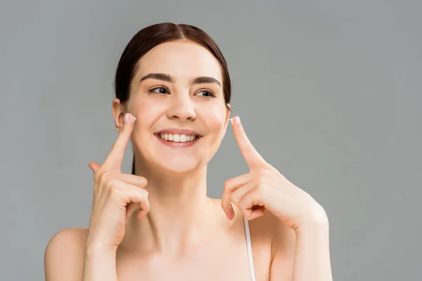 Cheerful Brunette Girl Face Cream Fingers Isolated Grey — Stock Photo, Image