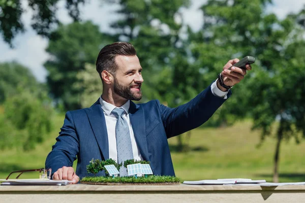 Young Businessman Glasses Sitting Table Sun Batteries Layout Looking Away — Stock Photo, Image