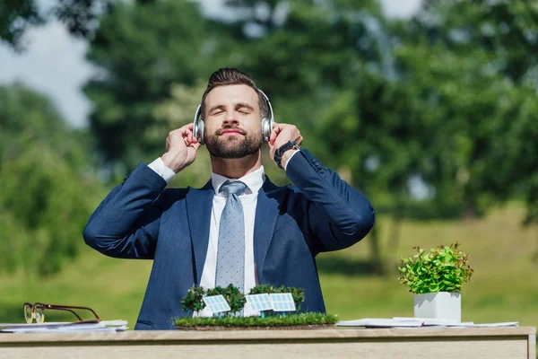 Young Businessman Sitting Table Sun Batteries Layout Flowerpot Relaxing While — Stock Photo, Image