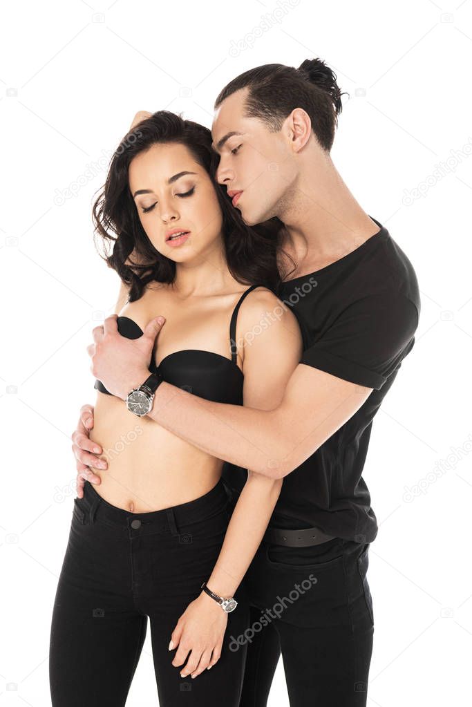 sexy couple in black clothes embracing isolated on white