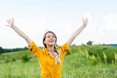 happy young woman with outstretched hands and closed eyes  clipart