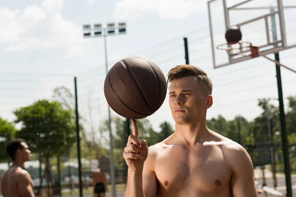 无衬衫篮球运动员与球在阳光明媚的日子篮球场 — 图库照片