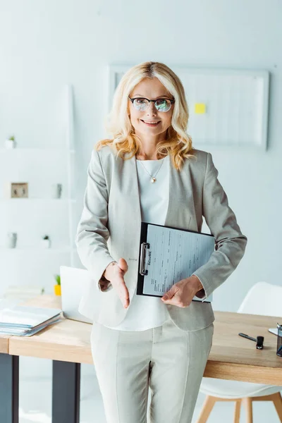 Attractive Blonde Woman Glasses Holding Clipboard Gesturing Office — Stock Photo, Image