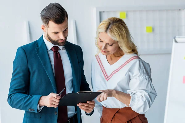 Handsome Recruiter Blonde Woman Looking Clipboard Office — Stock Photo, Image