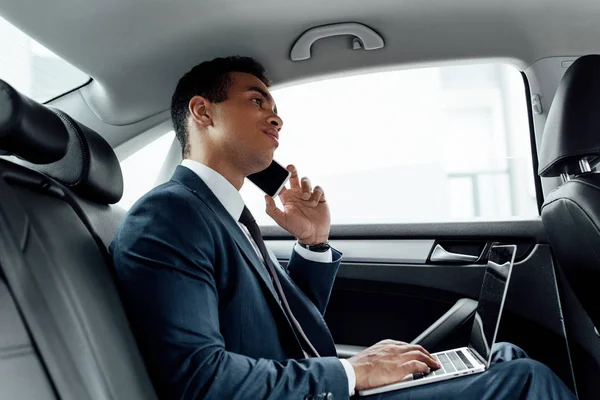 African American Businessman Suit Using Laptop While Talking Smartphone Car — Stock Photo, Image
