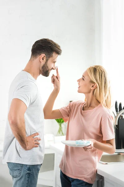 Beautiful Woman Putting Foam Smiling Man Kitchen Morning — Stock Photo, Image