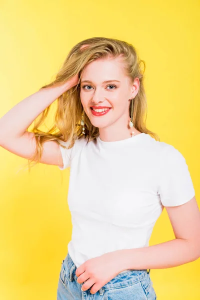 Beautiful Happy Blonde Young Woman Touching Hair Isolated Yellow — Stock Photo, Image