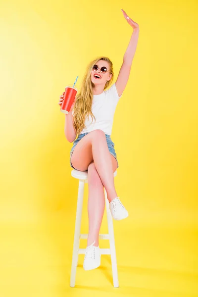Beautiful Girl Sunglasses Raised Hand Sitting Chair Holding Soda Drink — Stock Photo, Image
