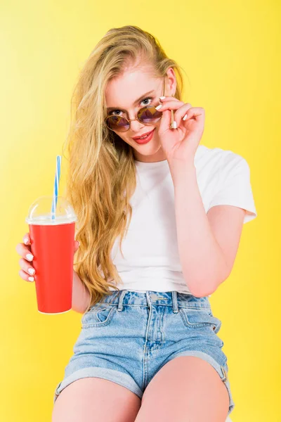 Beautiful Girl Sunglasses Drink Disposable Cup Looking Camera Isolated Yellow — Stock Photo, Image