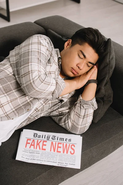 Tired Asian Man Sleeping Couch Home Newspaper Fake News — Stock Photo, Image