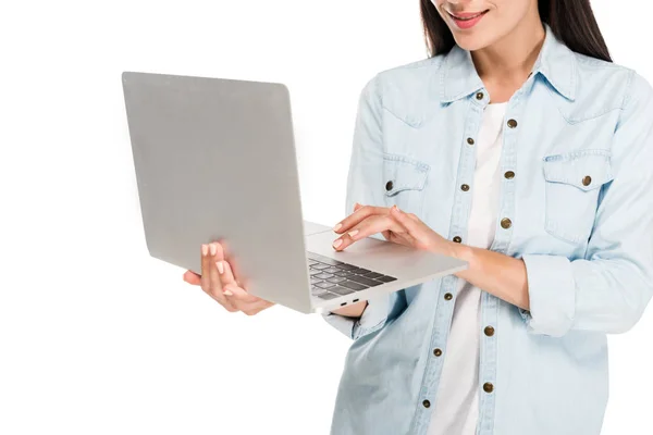 部分视图微笑的女孩在牛仔夹克使用笔记本电脑隔离在白色 — 图库照片