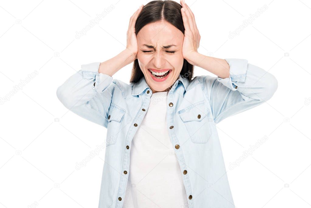 brunette woman screaming and suffering from headache isolated on white