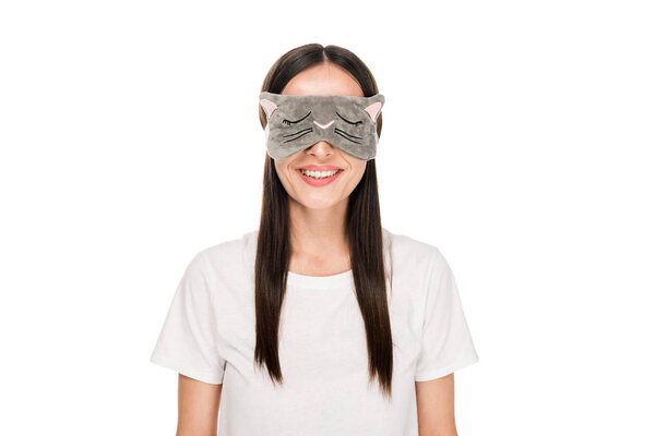 smiling brunette young woman in cat sleeping eye mask isolated on white