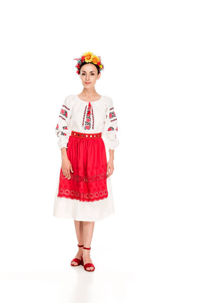 full length view of brunette young woman in national Ukrainian costume isolated on white