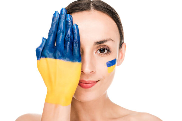 naked young woman with painted Ukrainian flag on face and hand isolated on white