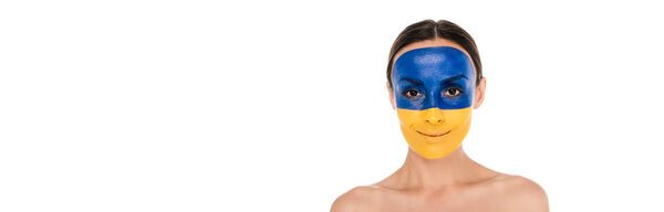 smiling naked young woman with painted Ukrainian flag on skin isolated on white, panoramic shot