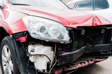 selective focus of damaged red automobile after car accident  clipart