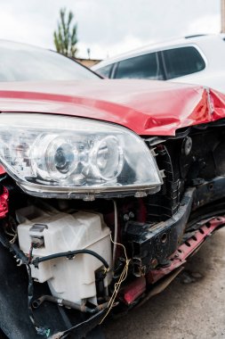 selective focus of damaged red vehicle after car accident  clipart