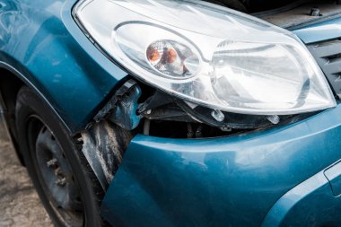 selective focus of crashed blue vehicle after car accident  clipart