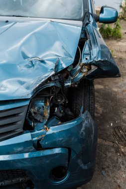 selective focus of crashed blue auto after car accident  clipart