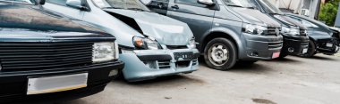 panoramic shot of damaged vehicle after car accident near modern automobiles clipart