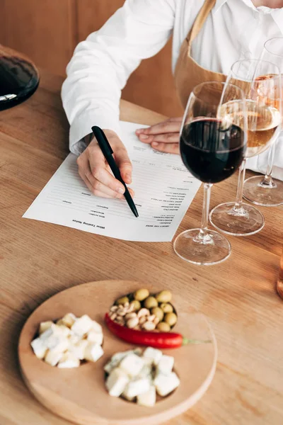 Cropped View Sommelier Apron Sitting Table Writing Wine Tasting Document — Stock Photo, Image