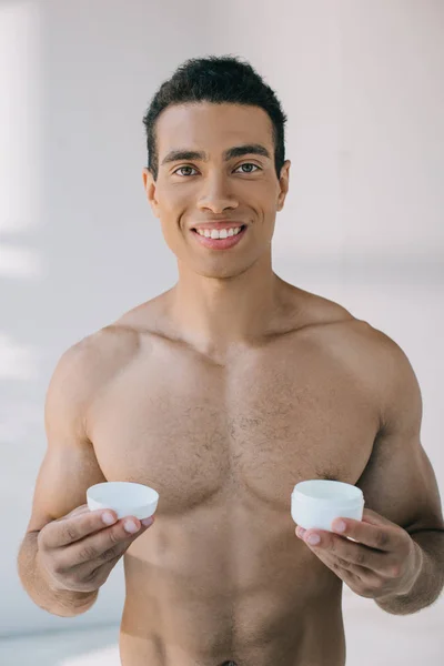 Handsome Mixed Race Man Holding Opened Container Cosmetic Cream Smiling — Stock Photo, Image