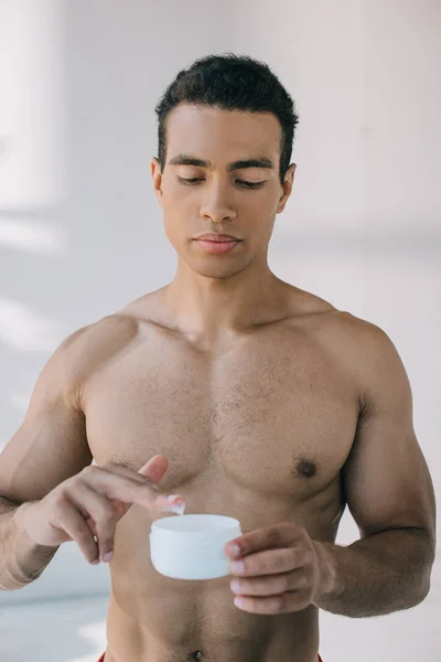 Serious Mixed Race Man Taking Some Cosmetic Cream Container — Stock Photo, Image