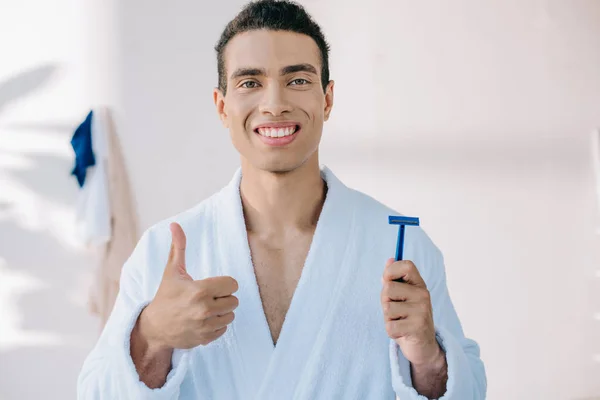 Handsome Man Bathrobe Holding Razor Shaving Showing Tumb While Smiling — Stock Photo, Image