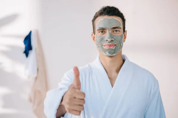 Handsome Man Face Mask Bathrobe Showing Thumb While Looking Camera — Stock Photo, Image