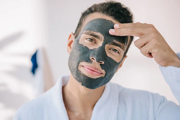 Confident Young Man Applying Face Mask Fingers Looking Camera — Stock Photo, Image