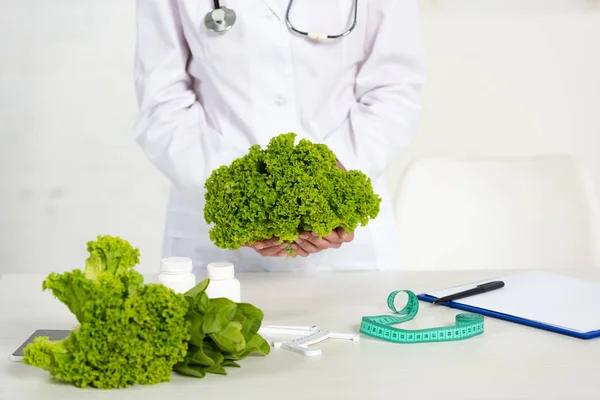 Cropped View Dietitian White Coat Holding Lettuce Workplace — Stock Photo, Image