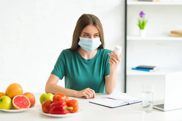 Woman Medical Mask Sitting Table Fruits Vegetables Holding Pills — Stock Photo, Image