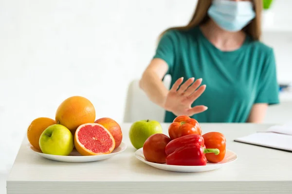 Cropped View Woman Medical Mask Refusing Fruits Vegetables Home — Stock Photo, Image