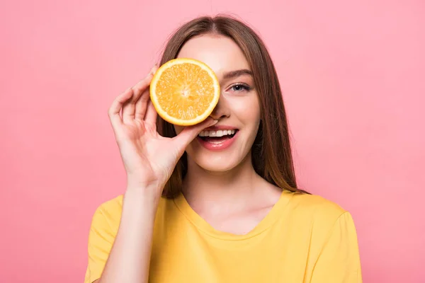 Visão Frontal Menina Atraente Sorrindo Segurando Laranja Corte Isolado Rosa — Fotografia de Stock