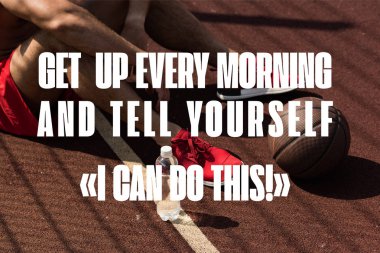 get up every morning and tell yourself I can do this lettering on partial view of sportsman in red sneakers with ball and bottle of water sitting at basketball court clipart