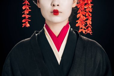 partial view of beautiful geisha in black and red kimono isolated on black clipart