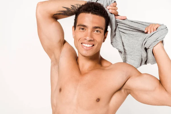 Cheerful Mixed Race Man Tattoo Holding Grey Shirt Looking Camera — Stock Photo, Image