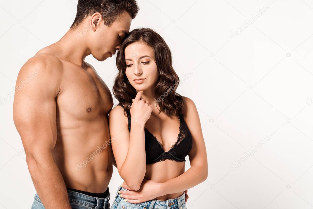 shirtless mixed race man standing with attractive girl on white 