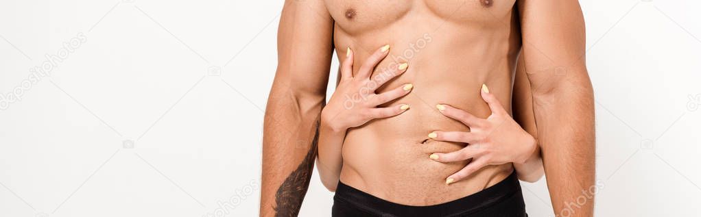 panoramic shot of woman touching sexy shirtless man isolated on white 