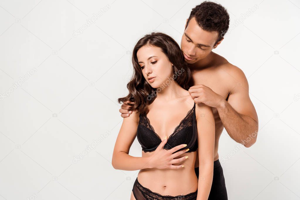 sexy mixed race man touching bra of seductive woman isolated on white 
