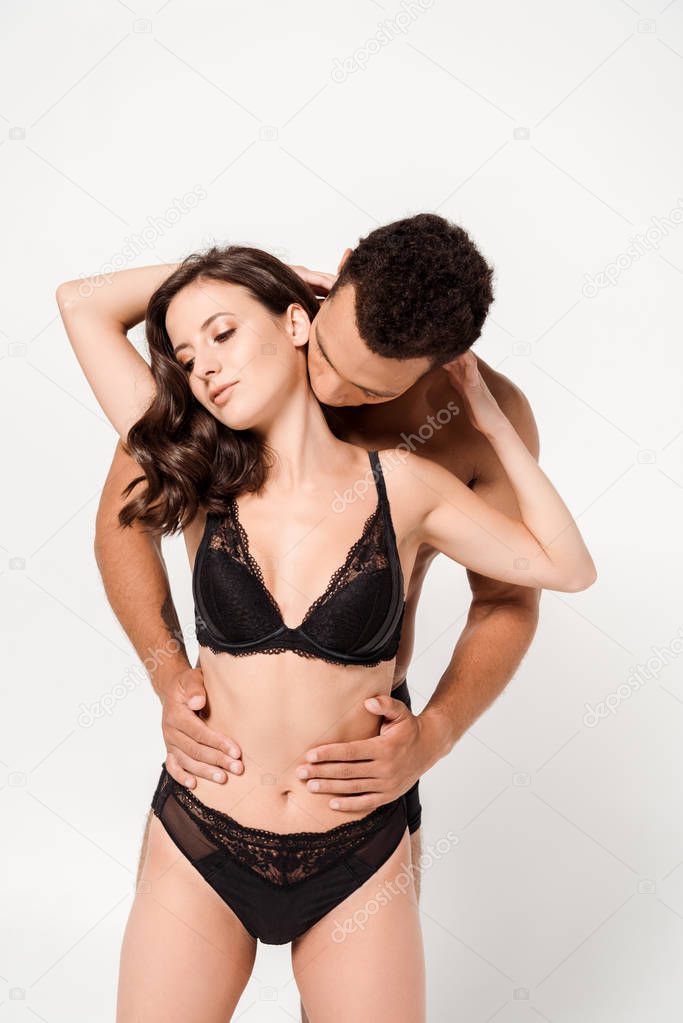 mixed race man touching sexy woman in underwear isolated on white 