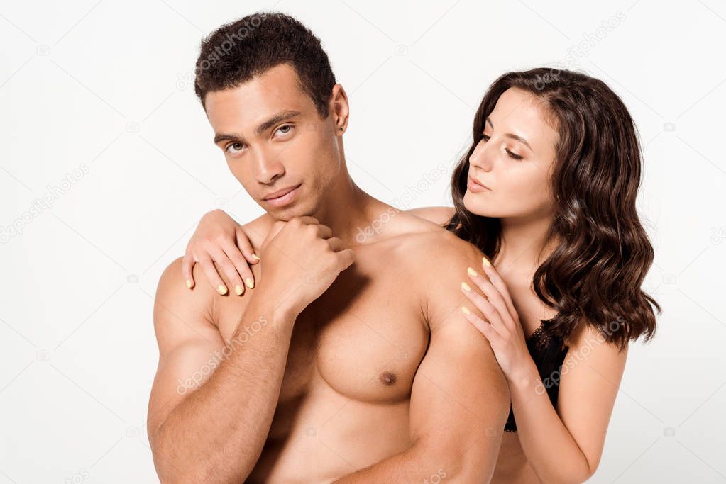 attractive woman looking at shirtless man touching face isolated on white 