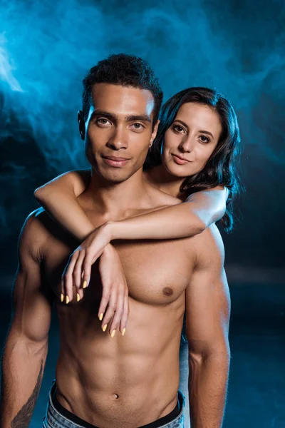 Shirtless Man Hugging Young Woman Standing in Lace Bra on Blue with Smoke.  Stock Image - Image of girl, together: 207979317