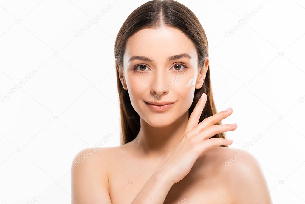 smiling young naked woman with perfect skin and cosmetic cream on face isolated on white