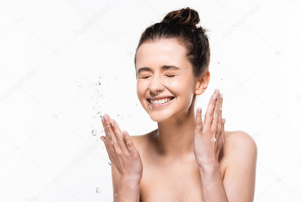 happy naked young brunette woman with natural beauty and closed eyes washing up with clean water splash isolated on white