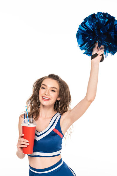 happy cheerleader girl in blue uniform holding pompom and soda in paper cup isolated on white